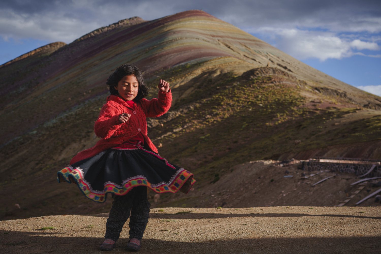 Dancing in front of the rainbow mountains | Peru Photo Tour with raw.tours