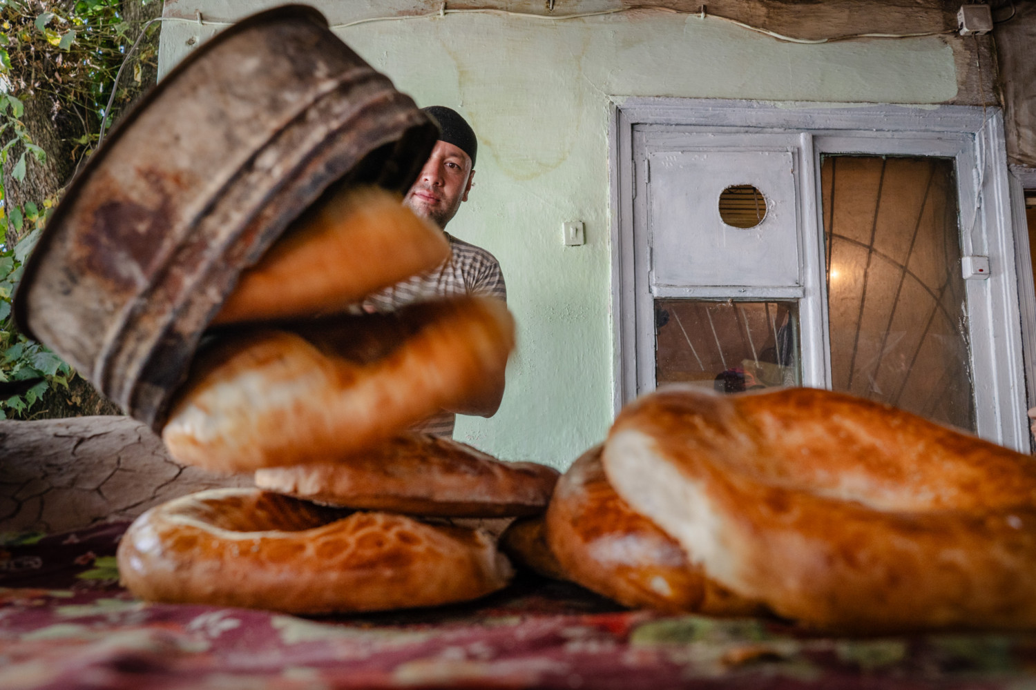 A baker pulls out freshly baked bread in Kyrgyzstan. A Fresh Perspectives in Travel Photography