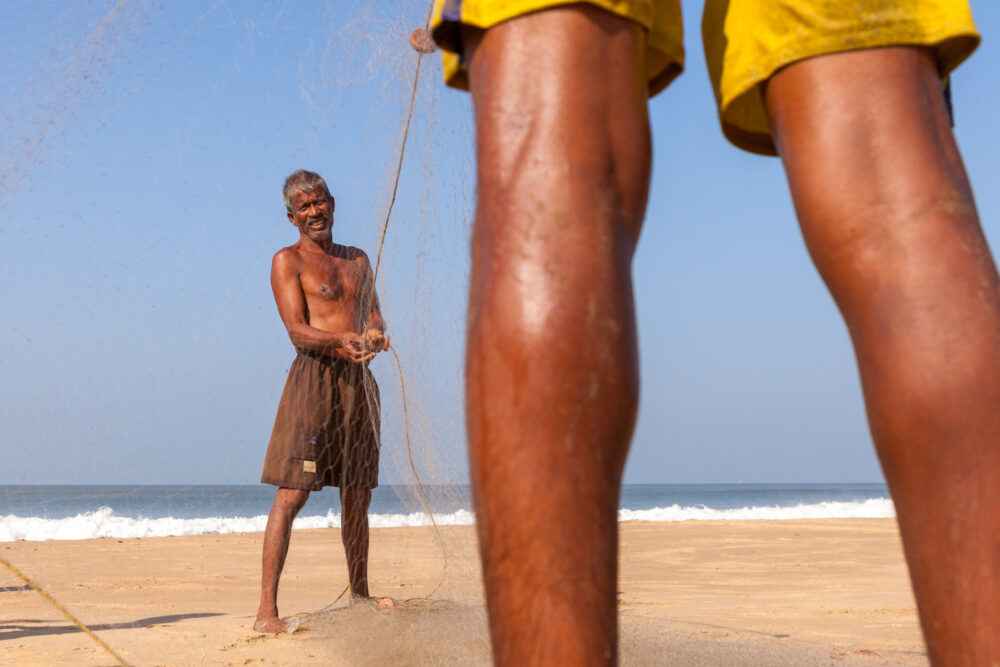 Fishermen Packing up Their Net After a Morning at Sea - Tom Bourdon Travel Photography