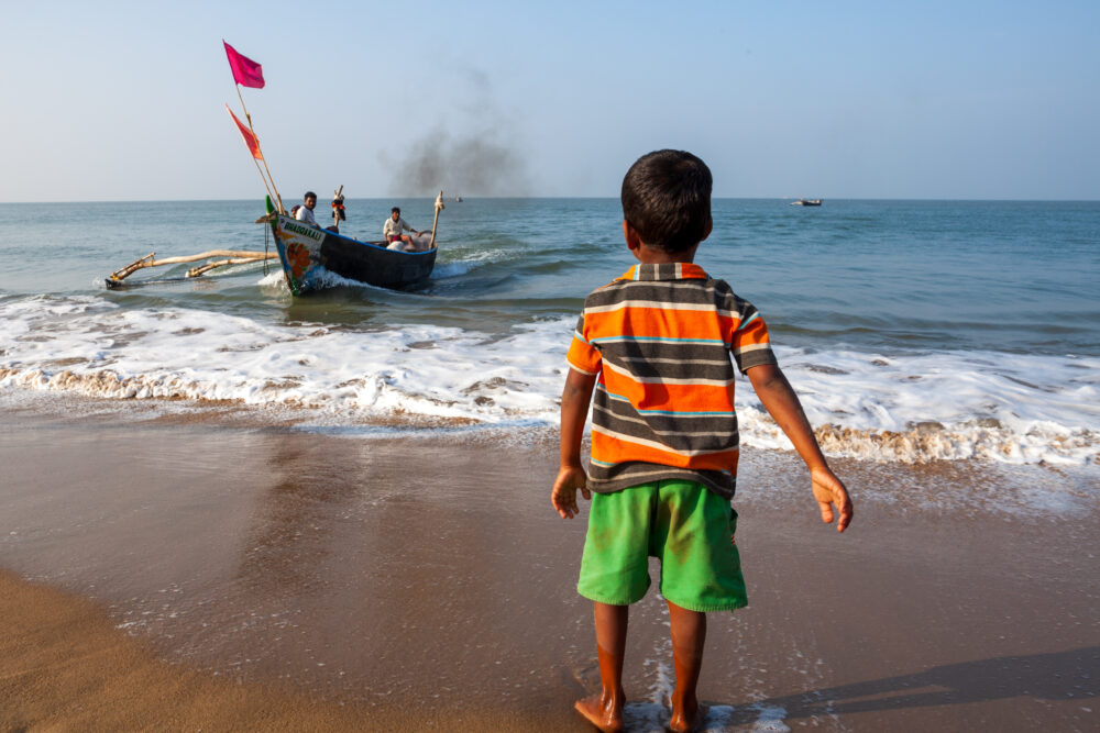 A Young Boy Waits for His Father to Return from the Sea - Tom Bourdon Travel Photography