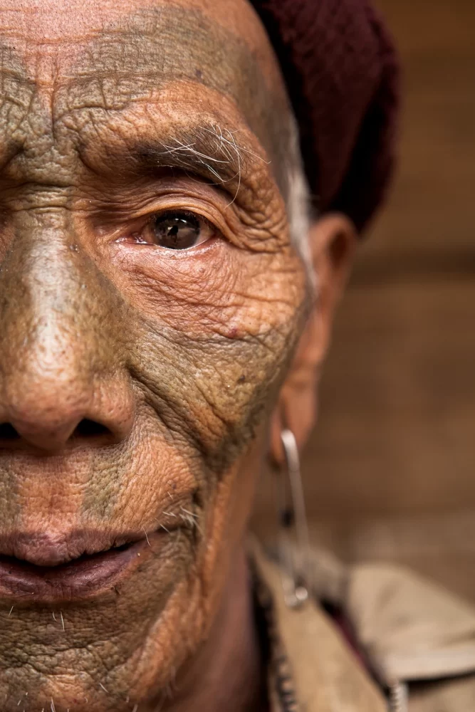 Naga Warrior with facial tattoos in rural India - Tom Bourdon Travel Photography