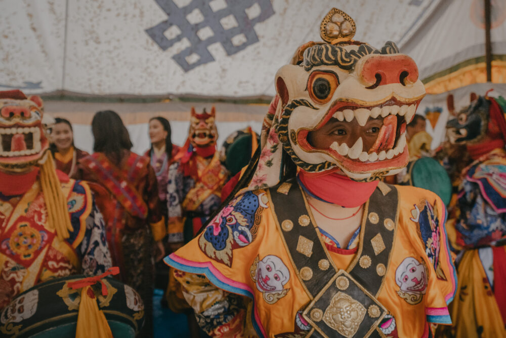A masked dancer prepares before the performance.
